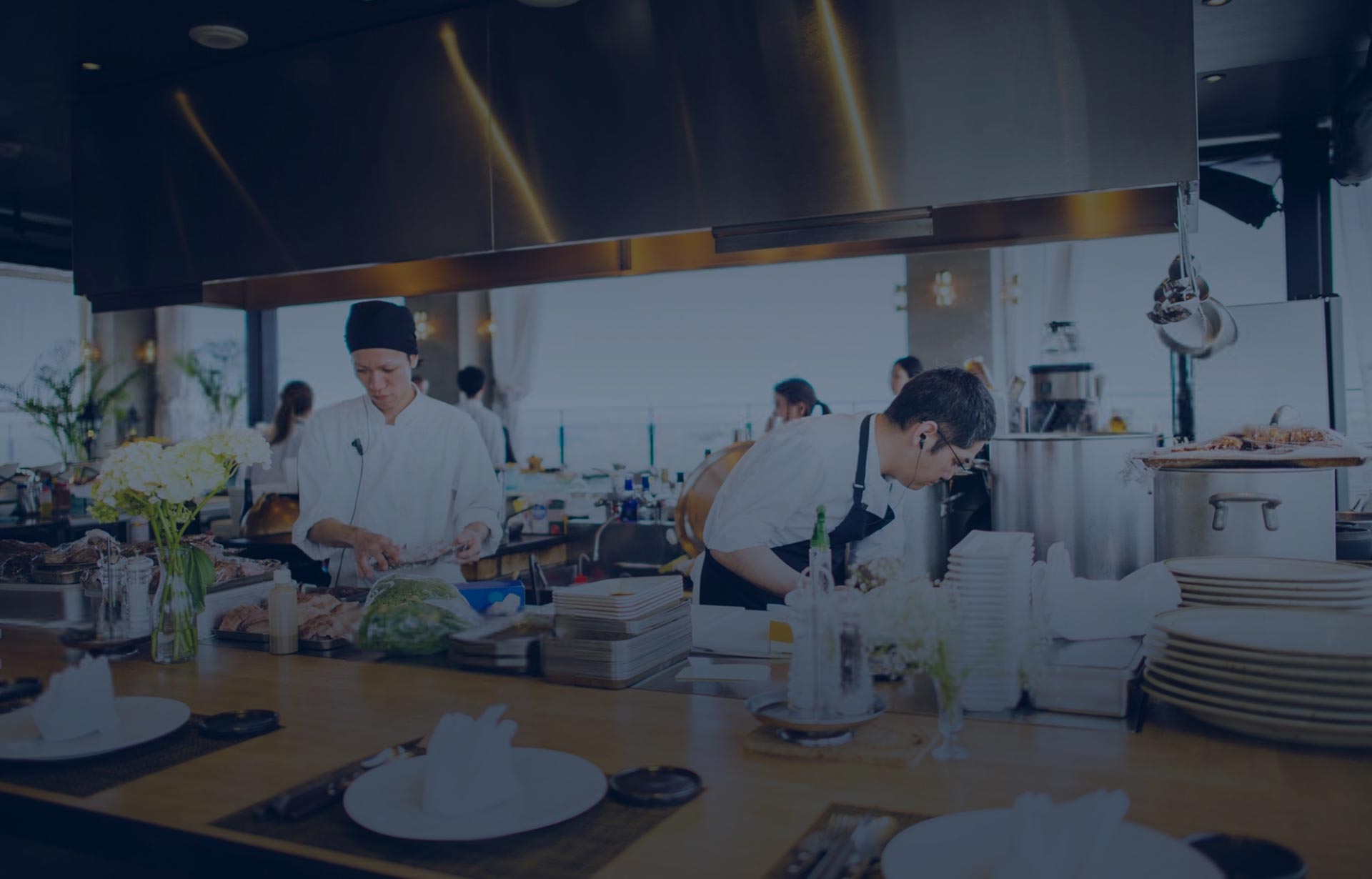 Chefs and cooks working in a clean, open kitchen