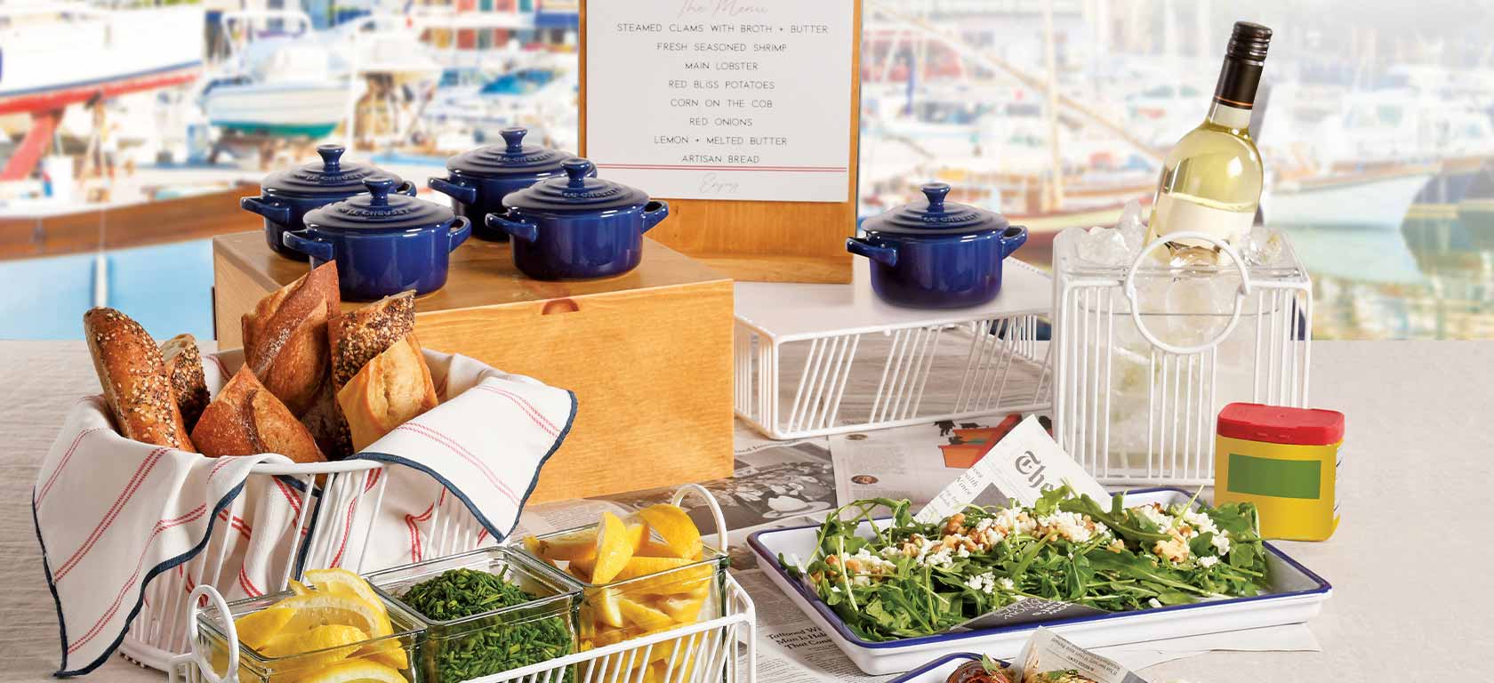 Array of blue ceramic pots rurrounded by fresh ingredients and a garden salad.