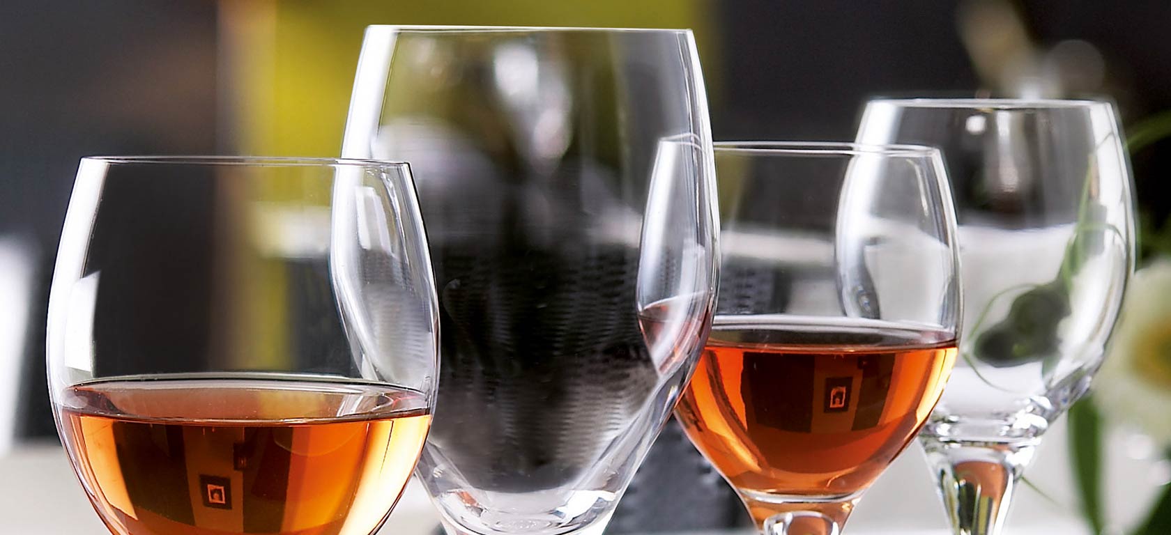 Close-up shot of crystal wine glasses holding amber liquid