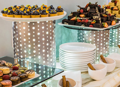 Chocolate and desert assortment arranged over chrome risers.