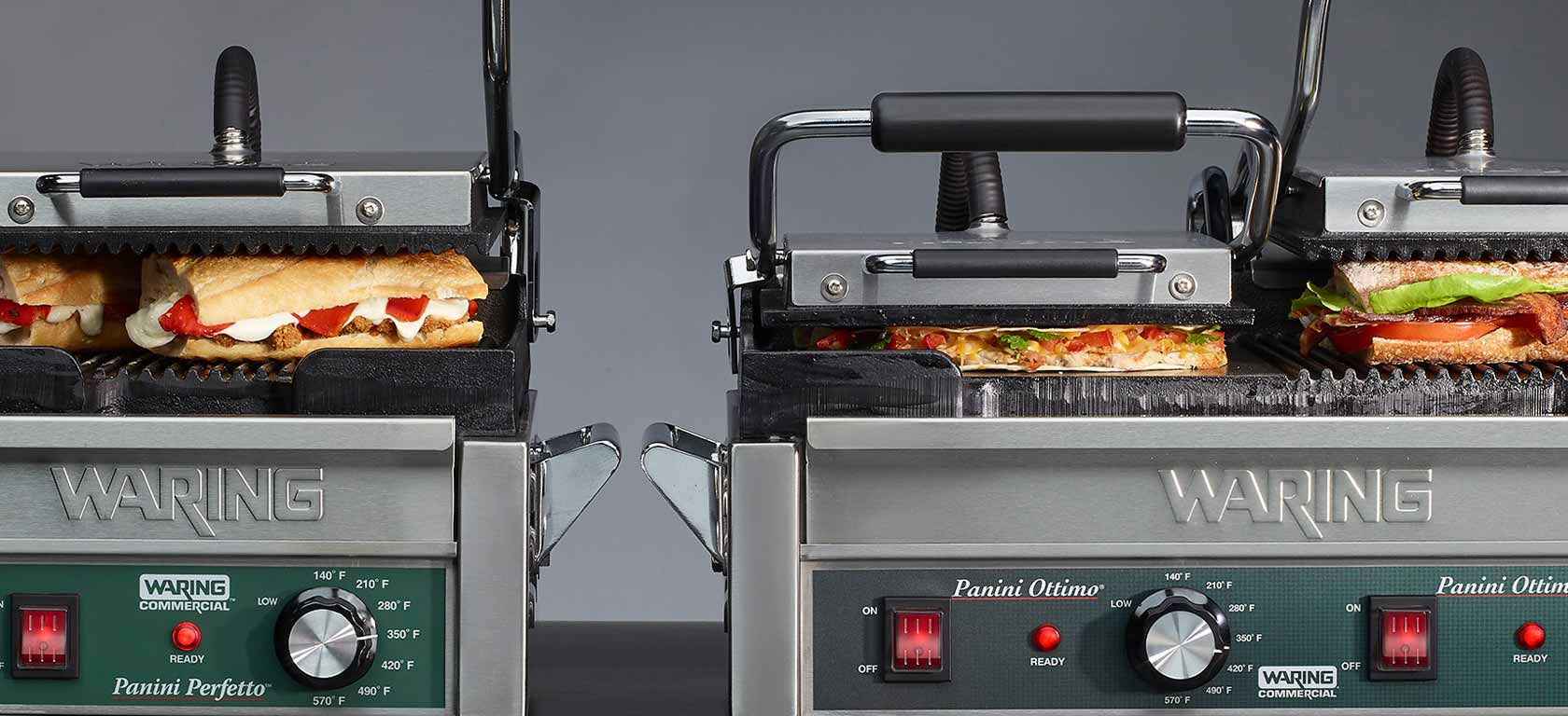 Two green-tinged chrome finished Waring panini presses side by side.